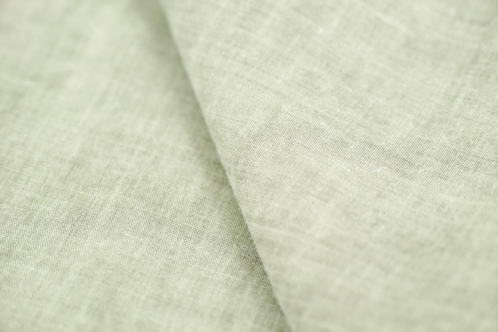A close-up of natural Irish linen fabric, showing the long-staple weave